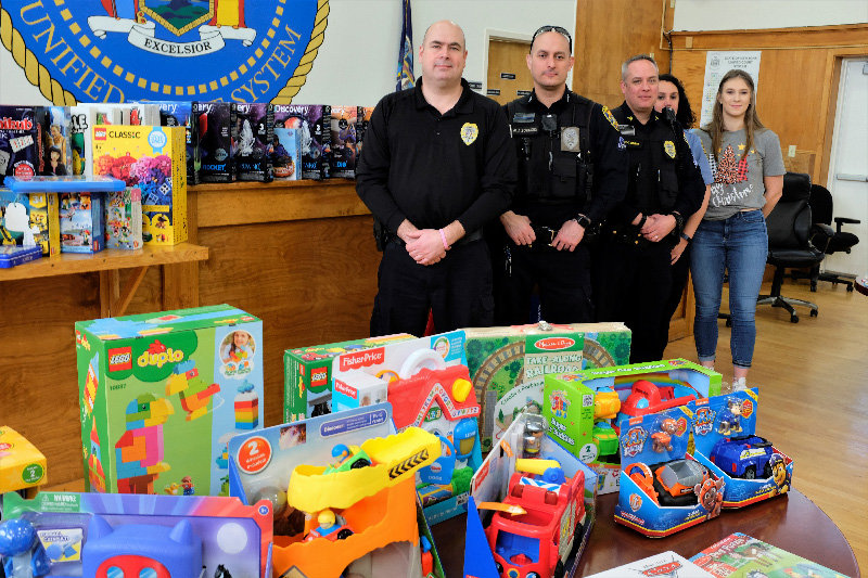 The Marlborough Police Department distributed a roomful of toys to families in need. Pictured L-R Chief Gerald Cocozza, Sgt. Mike Sotanski, Sgt. Chris Griggs, dispatcher Jennifer Van Amburgh and Georgie Super.